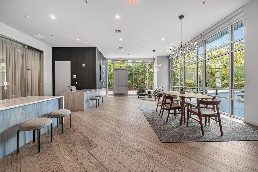 a dining room with a table and chairs in front of a large window