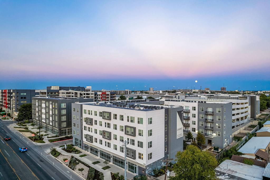 an aerial view of a city with buildings and the ocean in the background