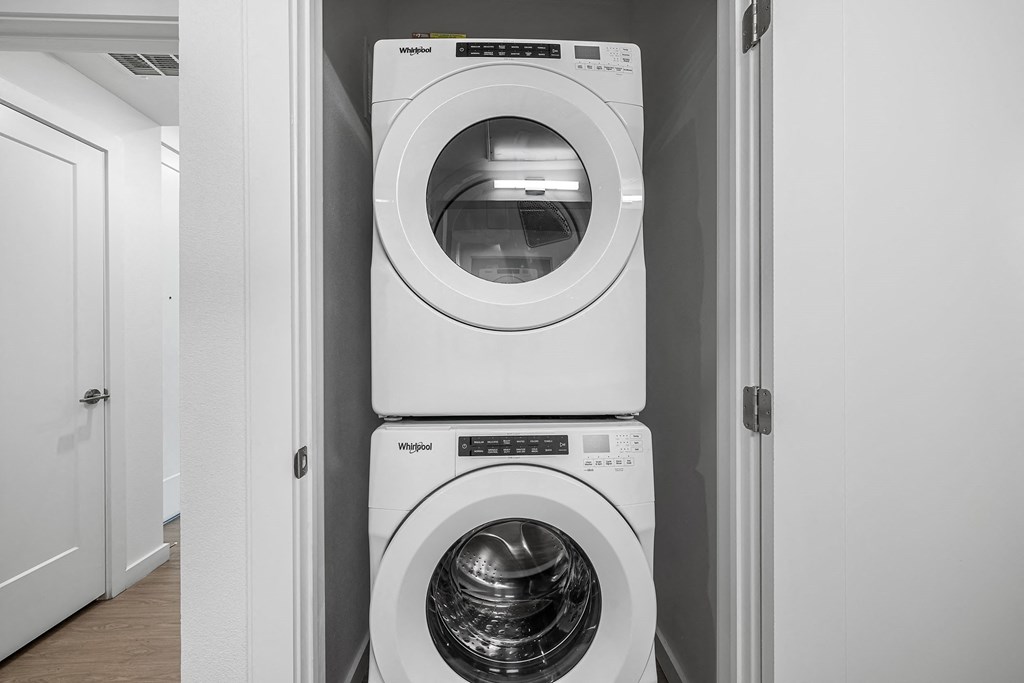 a white washer and dryer in a white laundry room