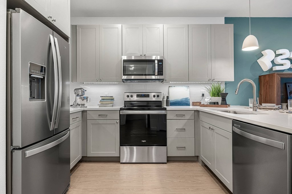 a kitchen with stainless steel appliances and white cabinets