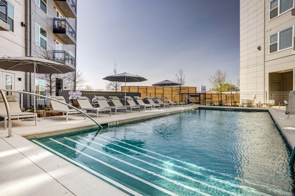 our apartments have a resort style pool with lounge chairs and umbrellas