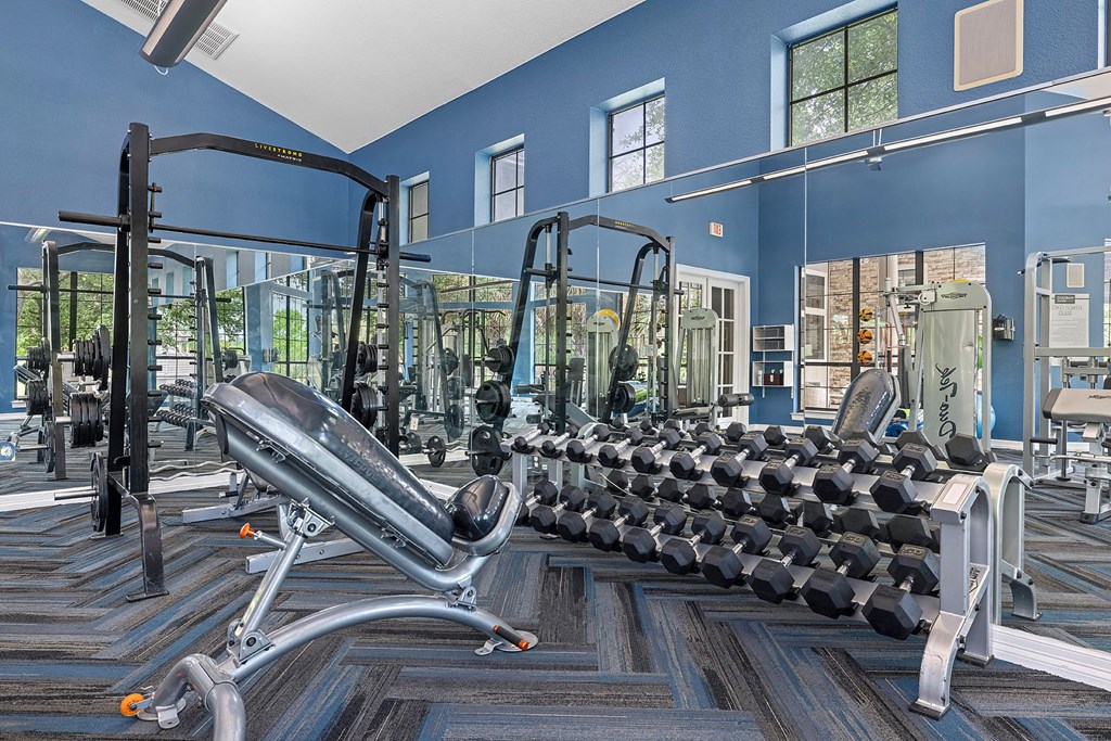 A gym with a variety of equipment including a leg press machine.
