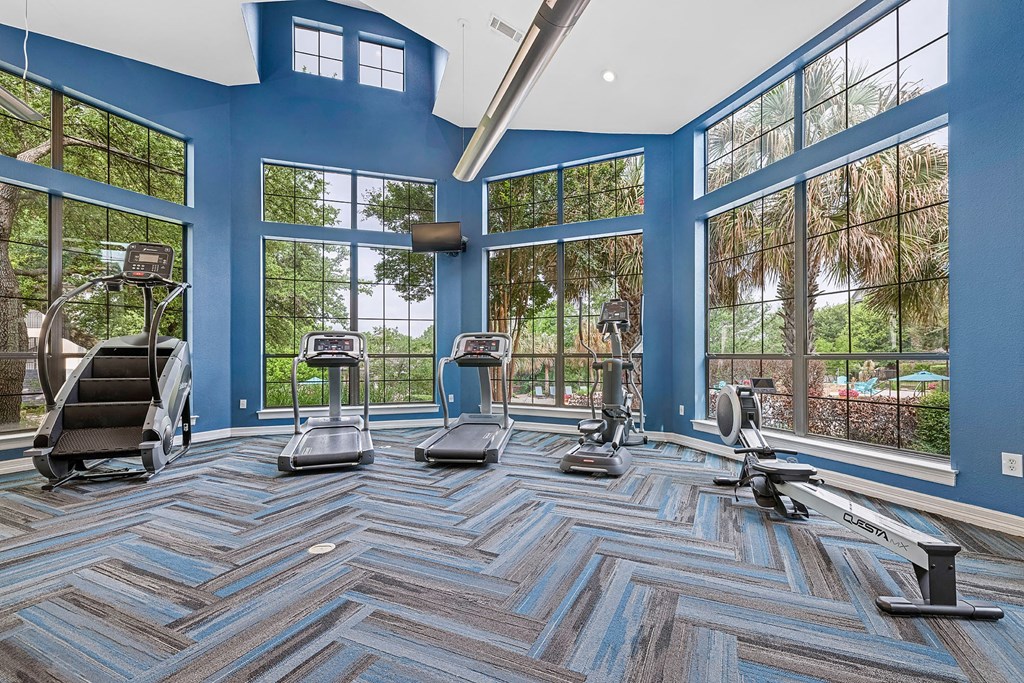 A gym with treadmills, elliptical machines, and a stair climber.