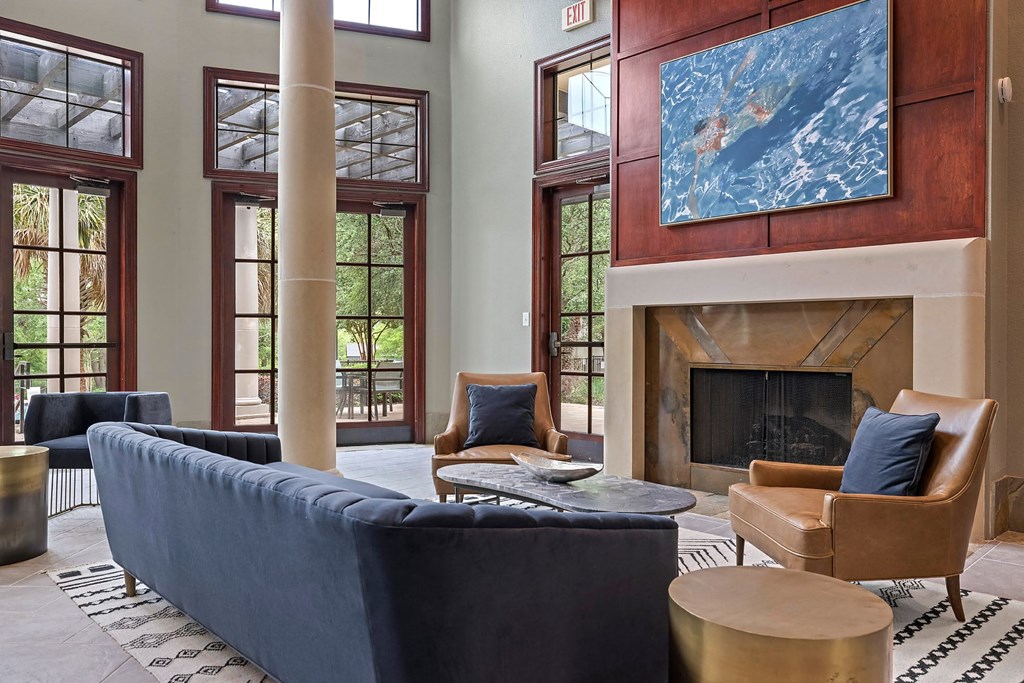 A living room with a fireplace and a painting on the wall.