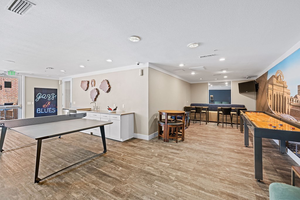 a game room with tables and chairs and a ping pong table