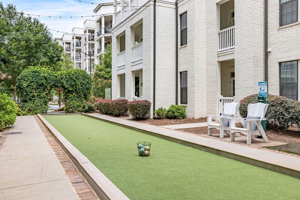 a potted plant sitting on a lawn in front of a white building