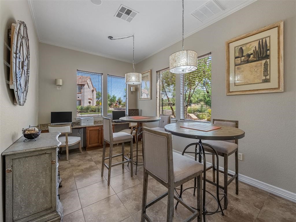 a dining room with a table and chairs