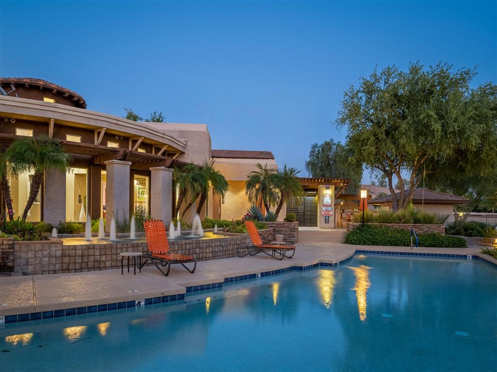 a swimming pool with a house in the background