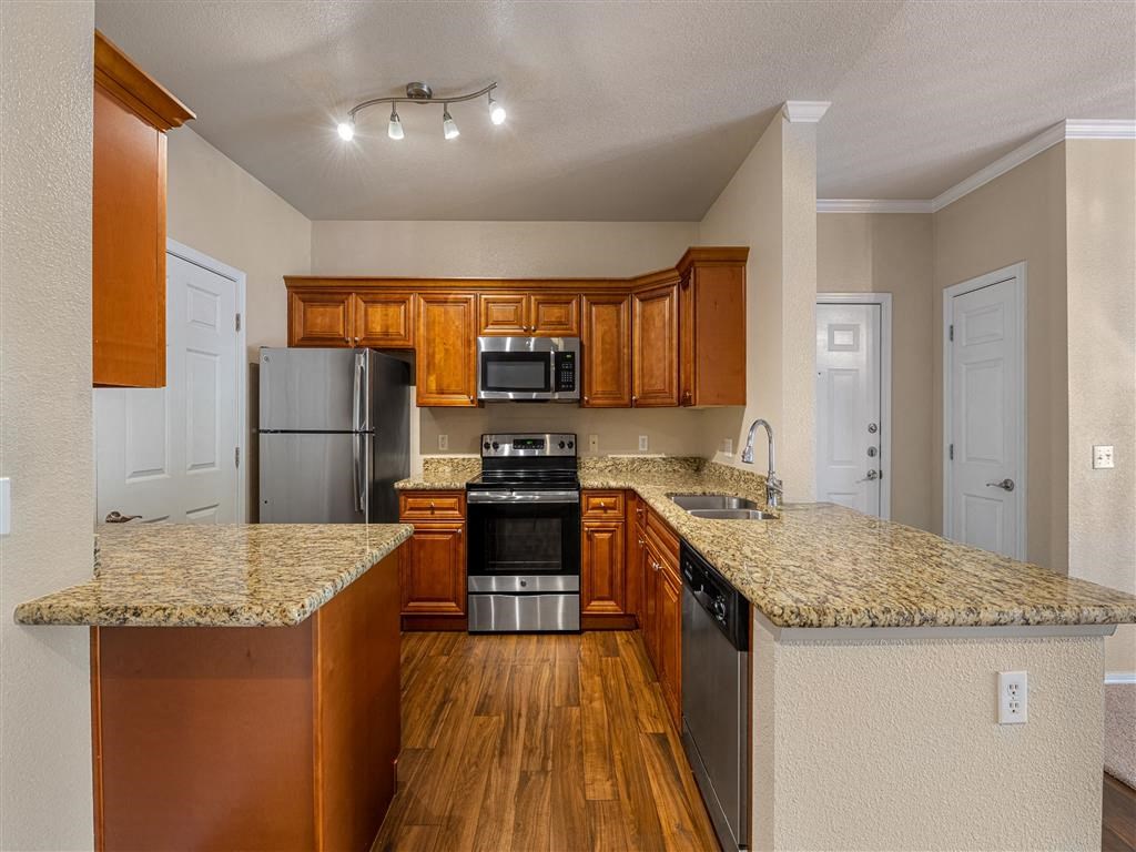 a kitchen with granite counter tops and stainless steel appliances