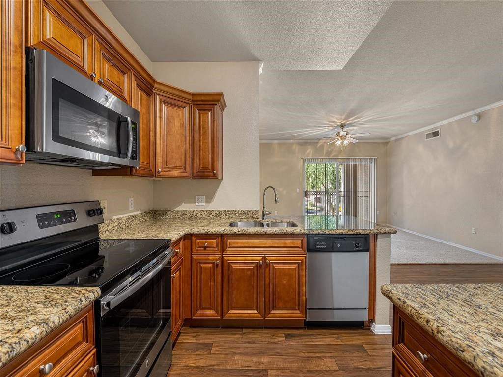a kitchen with a stove and a sink and a microwave