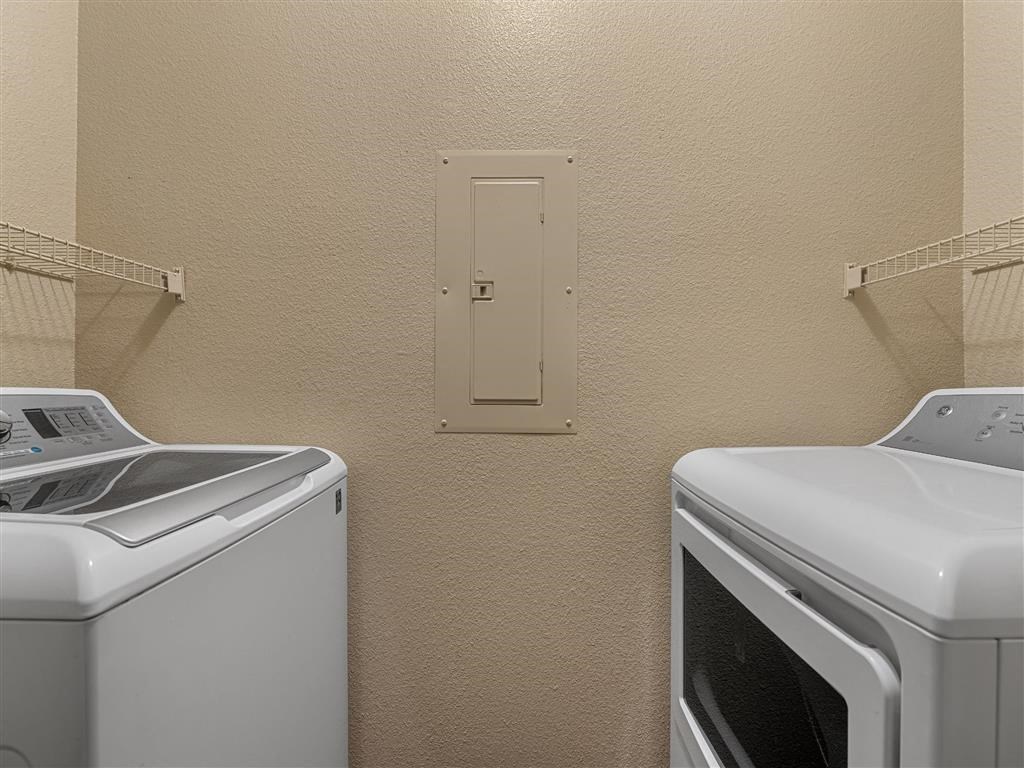 a laundry room with two washing machines and a door