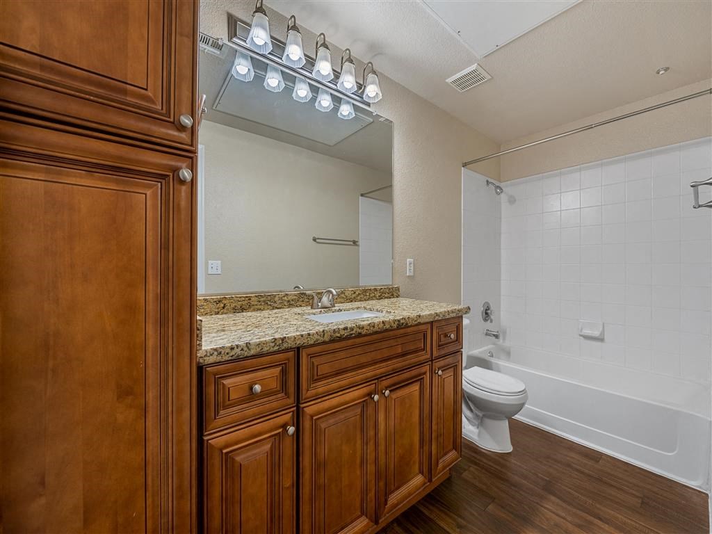 a bathroom with a sink toilet and a mirror