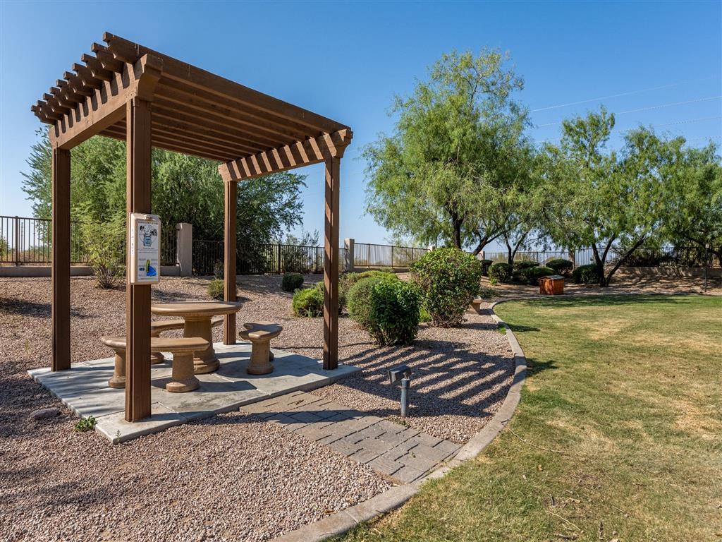 a picnic pavilion in a park with benches and trees
