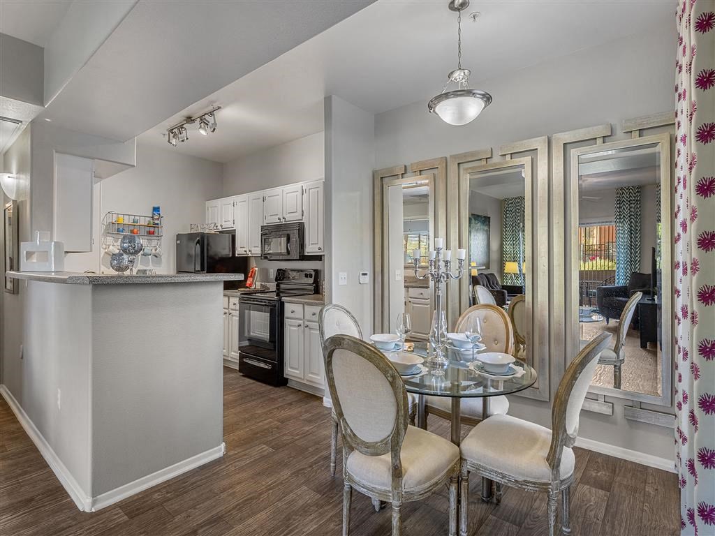 a kitchen and dining room with a table and chairs