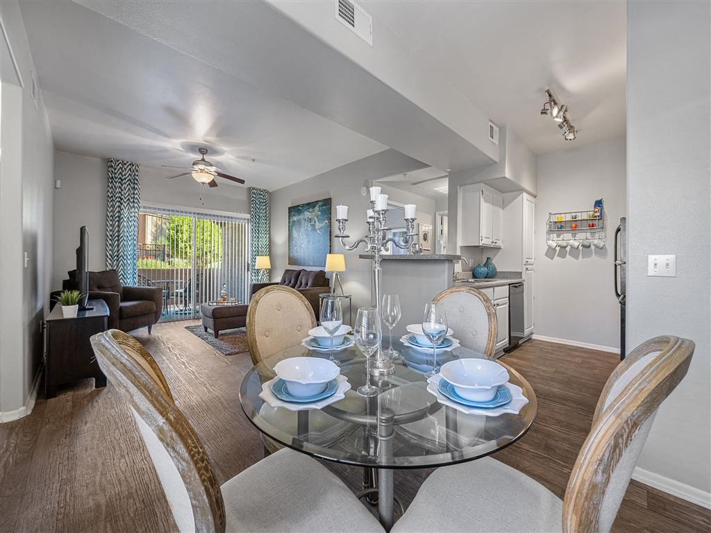 a dining room with a glass table and chairs