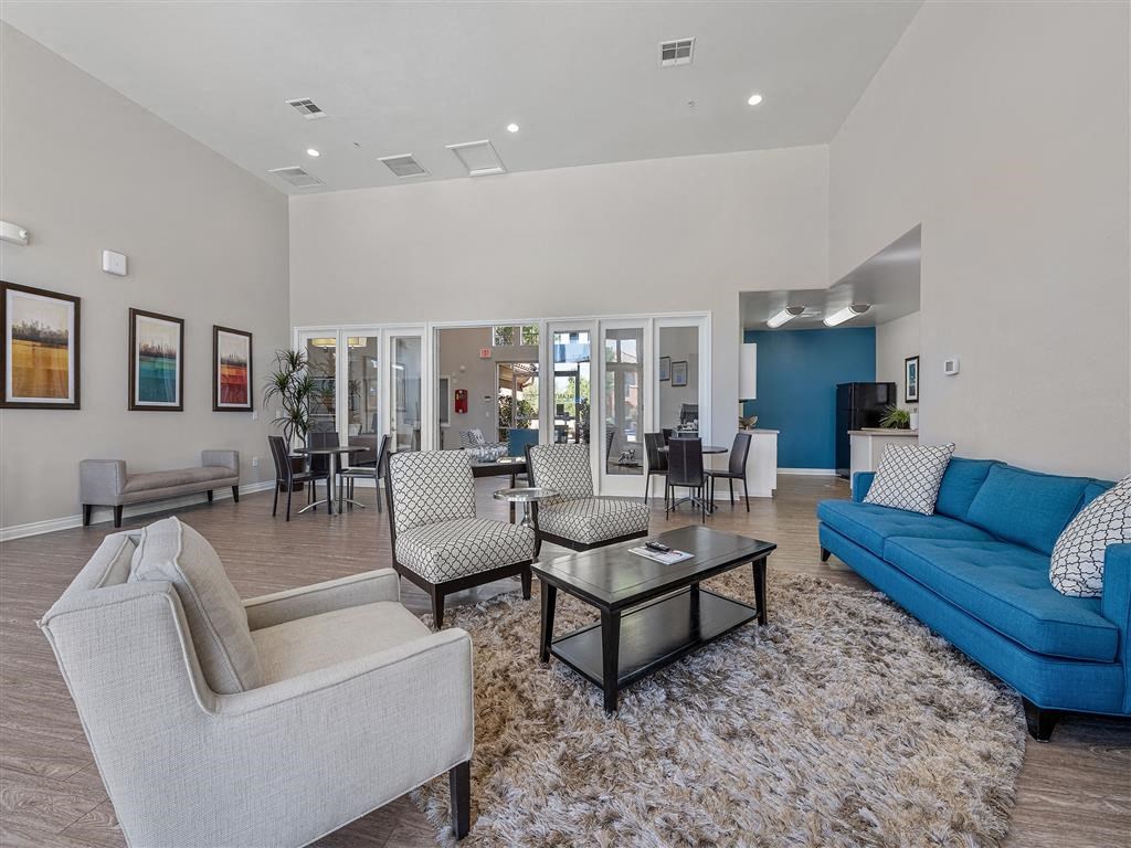 a living room with couches and chairs and a table