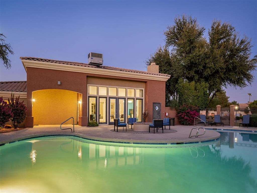 a swimming pool in front of a building with a pool