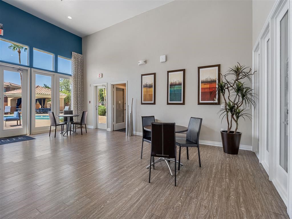 a dining room with a table and chairs and a large window
