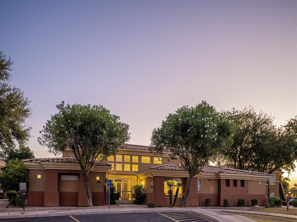 the building where the hotel is located is lit up at dusk