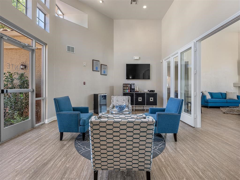 a living room with a table and chairs and a television