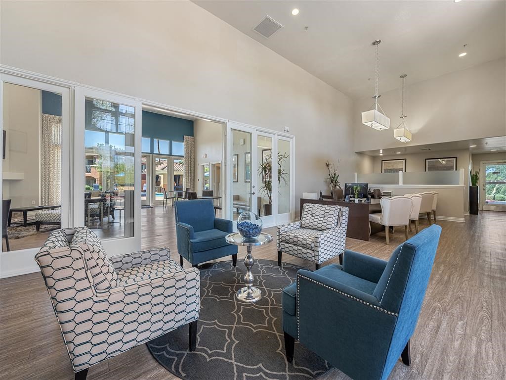 a living room with blue chairs and a table