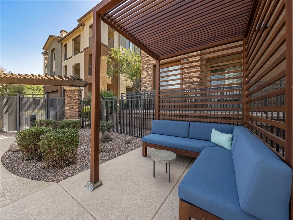 a patio with a couch and a coffee table