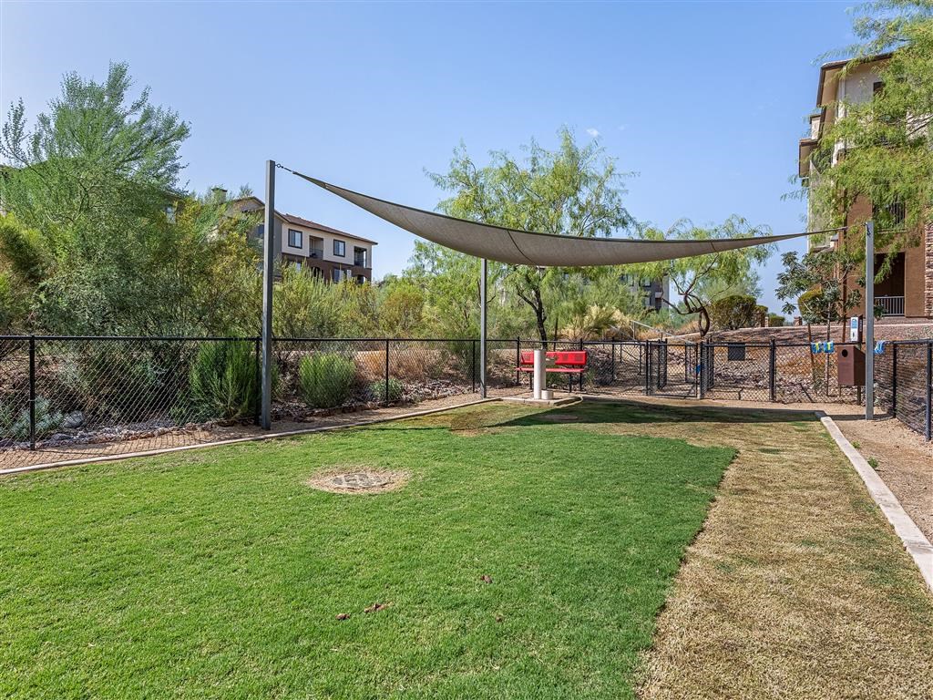 the yard is fenced in and has a dog park