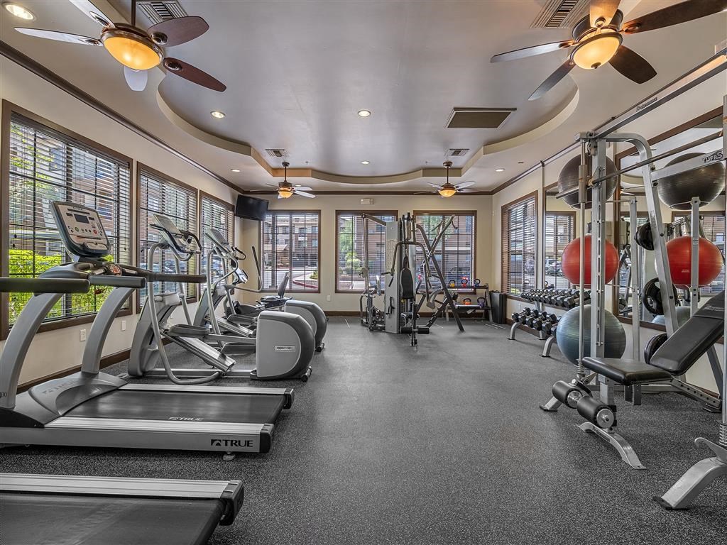 a gym with treadmills and other exercise equipment