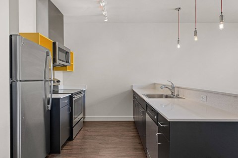 a kitchen with stainless steel appliances and a sink and refrigerator