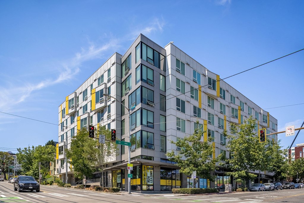 a large apartment building on the corner of a city street