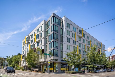 a large apartment building on the corner of a city street