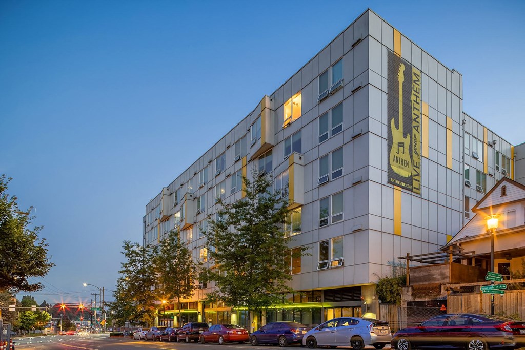a city street with cars parked in front of a building