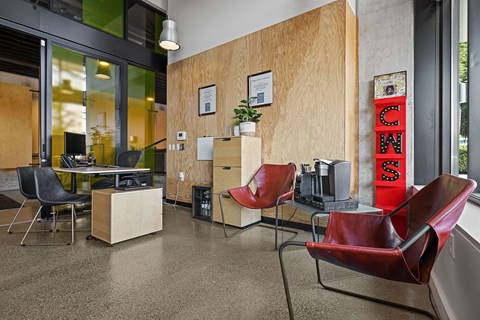 the lobby of an office with chairs and a tv