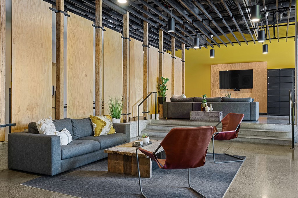 a living room with a couch and chairs and a tv