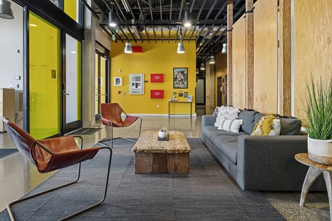 a living room with a couch and chairs and a coffee table