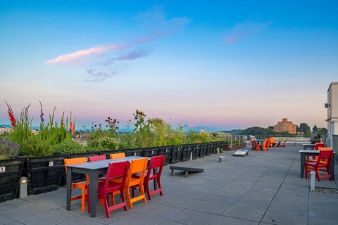 a rooftop patio with a view of the city and the ocean
