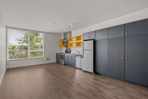 a large kitchen with stainless steel appliances and a large window
