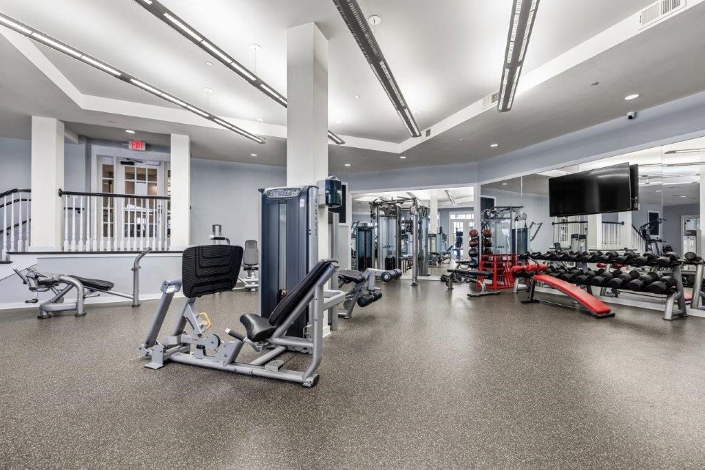 the gym is equipped with weights and cardio equipment at the apartments