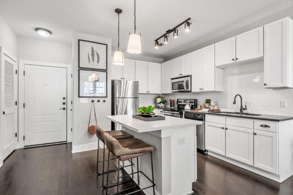 a kitchen with white cabinets and a white counter top