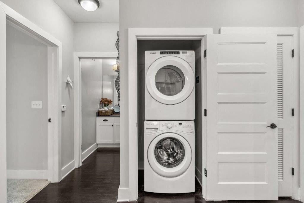 a white washer and dryer in a white closet