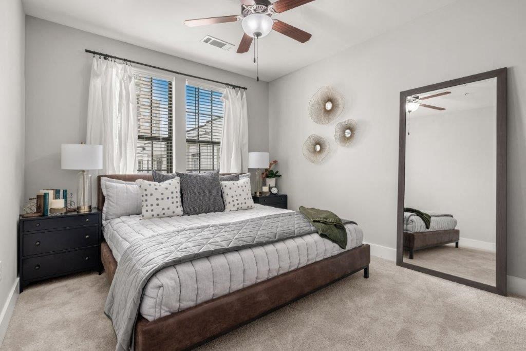 a bedroom with a bed and a ceiling fan