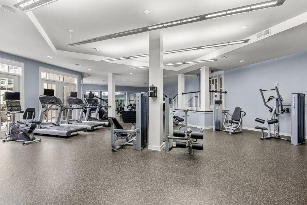 a gym with cardio equipment and weights in a building