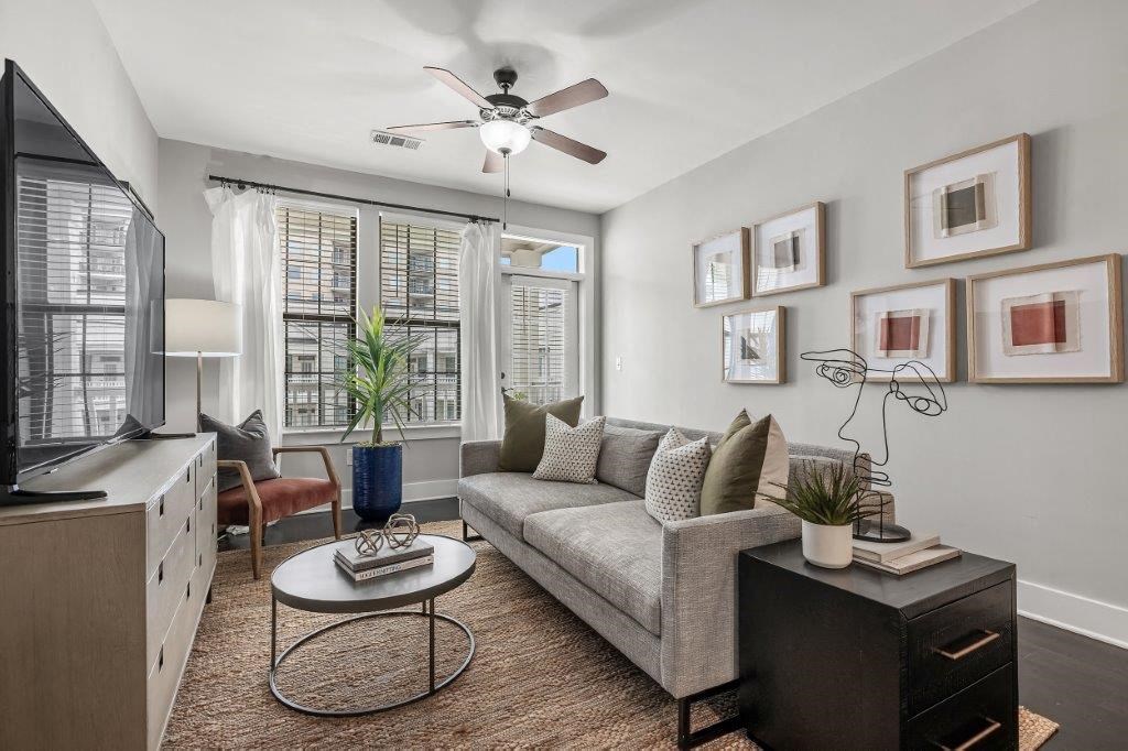 a living room with a couch and a ceiling fan