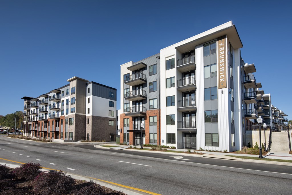 a rendering of a new apartment building on a city street