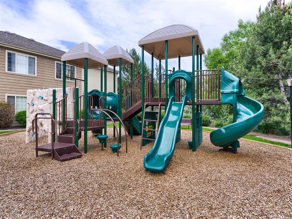 a playground with a slide and other playground equipment