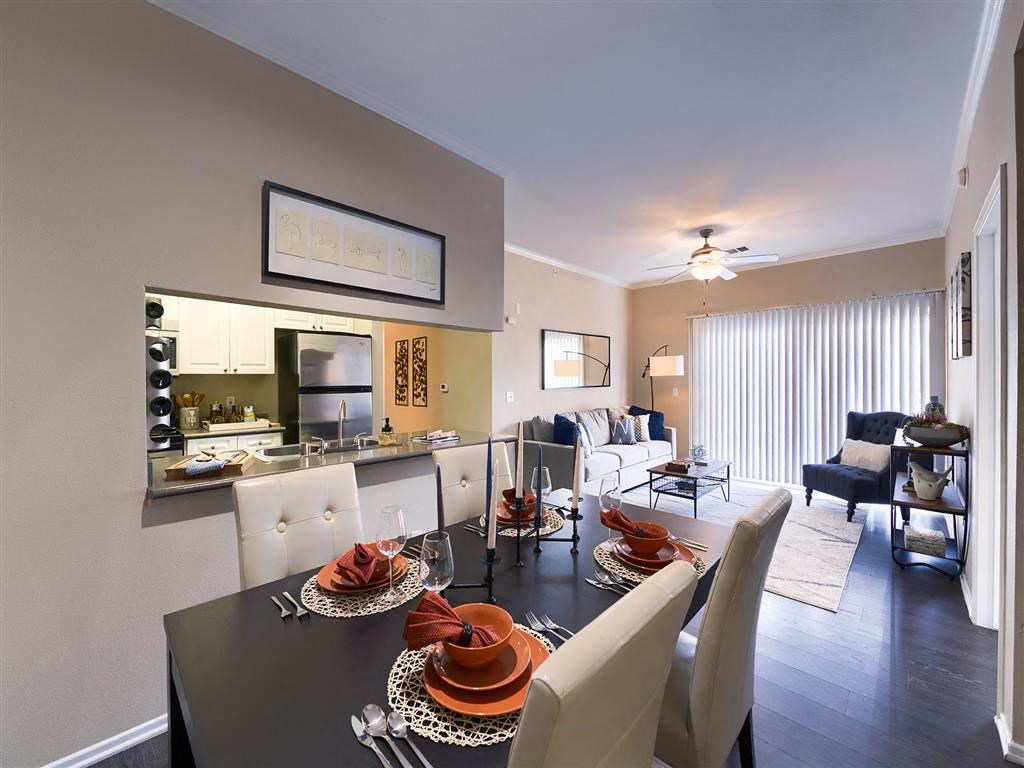 a dining room and living room with a table and chairs