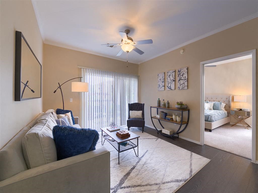 a living room with a couch and a ceiling fan