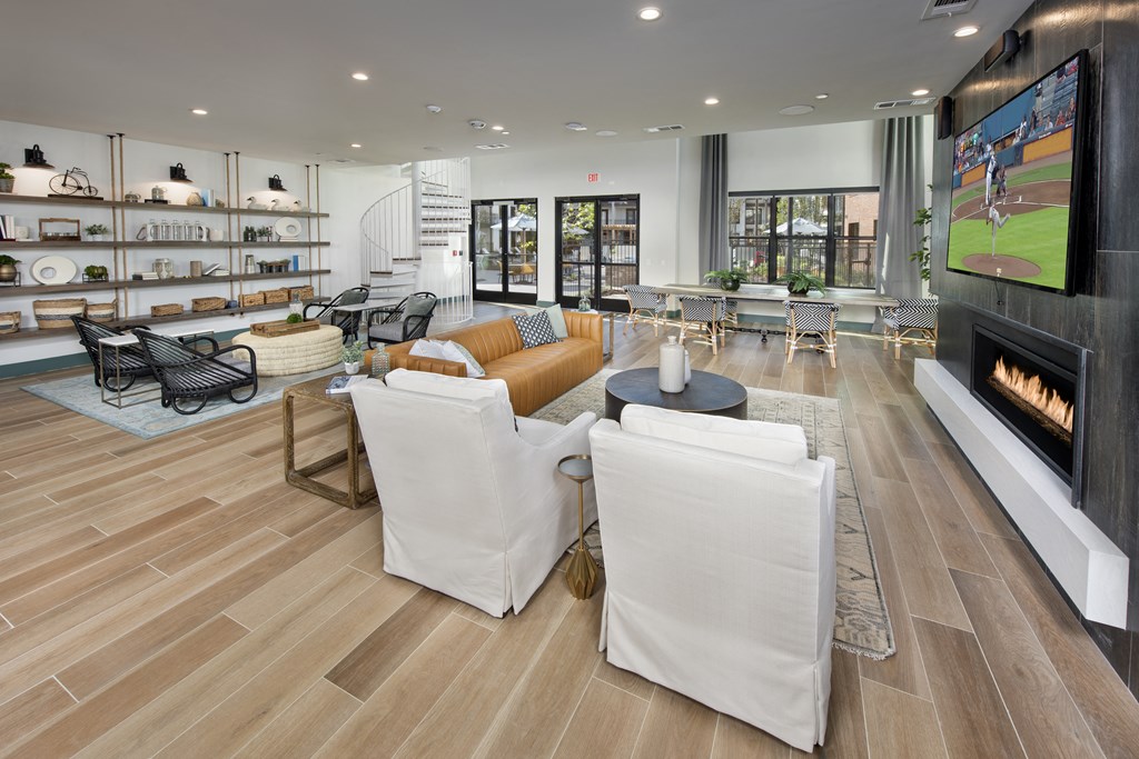 a living room with white furniture and a fireplace