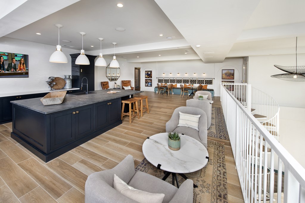a living room with a kitchen and a staircase