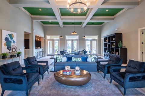 A living room with black chairs and a coffee table.